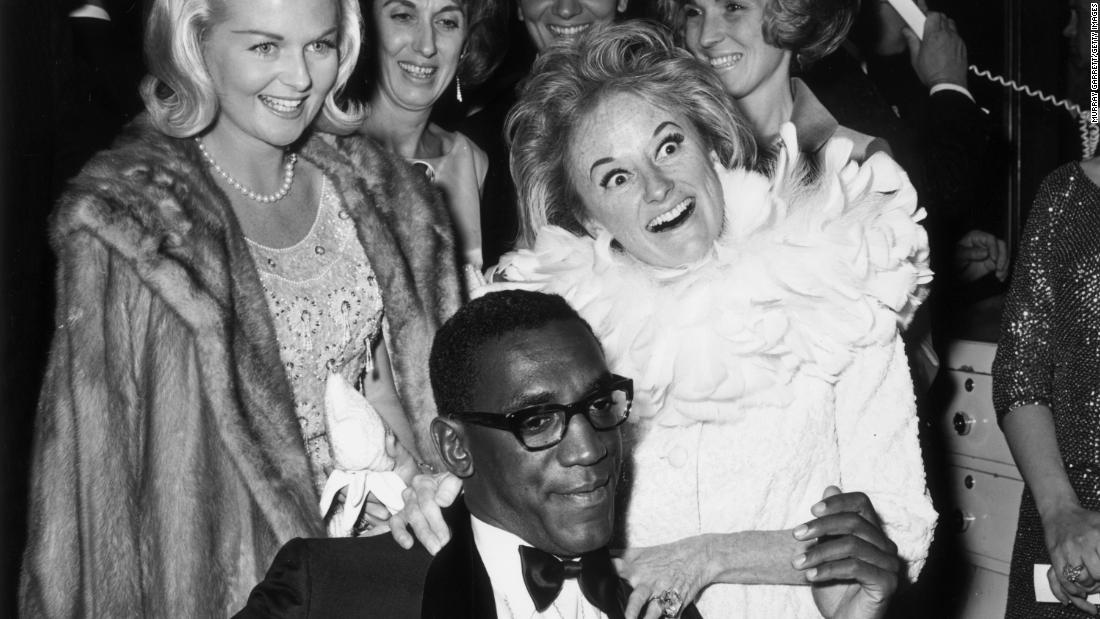 Cosby and fellow comedian Phyllis Diller attend a Hollywood party in the 1960s.