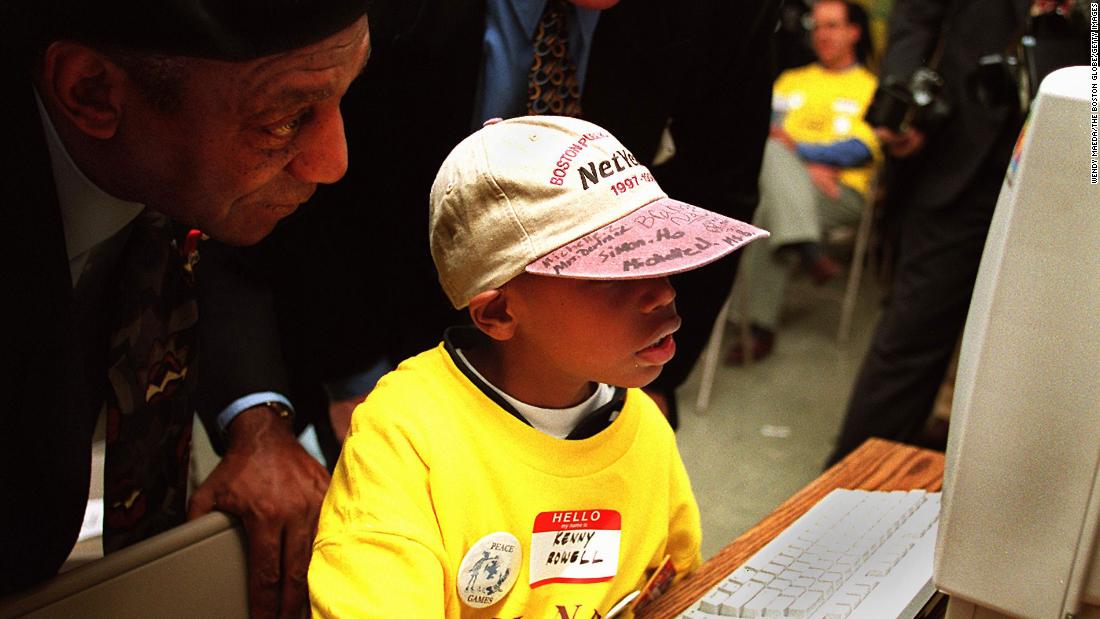 Cosby surfs the internet with 9-year-old Kenny Rowell as he visited a school in Boston with US Sen. Ted Kennedy in 1997.