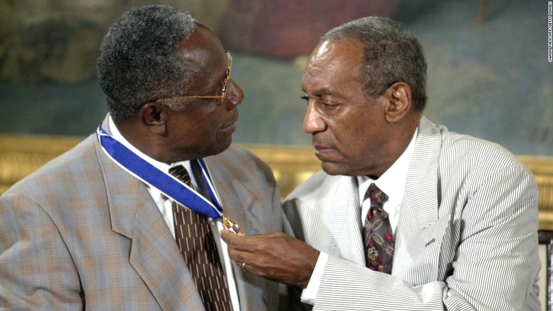 Cosby sits with baseball great Hank Aaron after they both received the Presidential Medal of Freedom in 2002. The medal is America&#39;s highest civilian award.