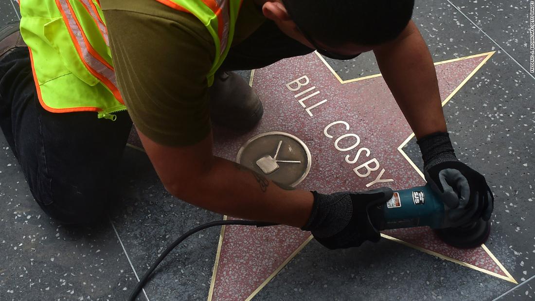 A worker cleans actor Cosby&#39;s star on the Hollywood Walk of Fame after someone vandalized it in December 2014. This was after some of the allegations against Cosby had come to light.
