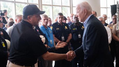 US President Joe Biden(R) shakes hands with Jimmy Patronis, Florida&#39;s Chief Financial Officer, as he meets with first responders to the collapse of the 12-story Champlain Towers South condo building in Surfside, during a meeting with them in Miami Beach, Florida, July 1, 2021. - President Joe Biden flew to Florida on Thursday to &quot;comfort&quot; families of people killed or still missing in the rubble of a beachfront apartment building, where hopes of finding survivors had all but evaporated. Biden and First Lady Jill Biden left the White House early for the flight to Miami, and then traveled by motorcade to nearby Surfside, where the death toll in the tragedy now stands at 18, and more than 140 still unaccounted for. (Photo by SAUL LOEB/AFP via Getty Images)