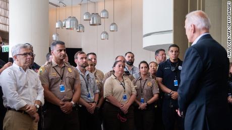 US President Joe Biden greets first responders to the collapse of the 12-story Champlain Towers South condo building in Surfside, during a meeting with them in Miami Beach, Florida, July 1, 2021. - President Joe Biden flew to Florida on Thursday to &quot;comfort&quot; families of people killed or still missing in the rubble of a beachfront apartment building, where hopes of finding survivors had all but evaporated. Biden and First Lady Jill Biden left the White House early for the flight to Miami, and then traveled by motorcade to nearby Surfside, where the death toll in the tragedy now stands at 18, and more than 140 still unaccounted for. (Photo by SAUL LOEB / AFP) (Photo by SAUL LOEB/AFP via Getty Images)