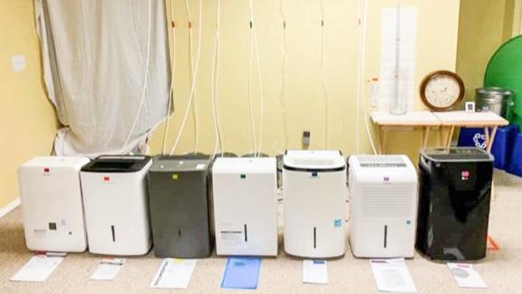 All the tested dehumidifiers set up for our pump hose test.