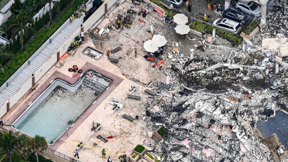 This aerial view, shows search and rescue personnel working on site after the partial collapse of the Champlain Towers South in Surfside, north of Miami Beach, on June 24, 2021. - The multi-story apartment block in Florida partially collapsed early June 24, sparking a major emergency response. Surfside Mayor Charles Burkett told NBCs Today show: My police chief has told me that we transported two people to the hospital this morning at least and one has died. We treated ten people on the site. (Photo by CHANDAN KHANNA / AFP) (Photo by CHANDAN KHANNA/AFP via Getty Images)