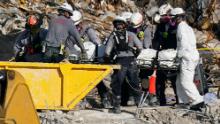 Search and rescue personnel work atop the rubble at the Champlain Towers South condo building on Friday, July 2.