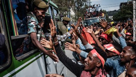 People try to shake hands with soldiers of Tigray Defence Force (TDF) as they arrive in Mekelle, the capital of Tigray region, Ethiopia, on June 29.