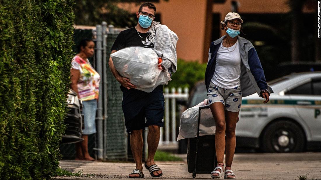 Residents of the Crestview Towers Condominium carry their belongings &lt;a href=&quot;https://www.cnn.com/2021/07/02/us/north-miami-crestview-condo-building-ordered-closed/index.html&quot; target=&quot;_blank&quot;&gt;as they leave their building &lt;/a&gt;in North Miami Beach, Florida, on July 2. The building, about 6 miles from Surfside, was deemed to be structurally and electrically unsafe based on a delinquent recertification report for the almost 50-year-old building. The city said the move was out of an &quot;abundance of caution,&quot; as area authorities check high-rise condo buildings following the Surfside collapse.
