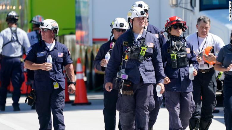 Members of the South Florida Urban Search and Rescue team walk near Champlain Towers South.