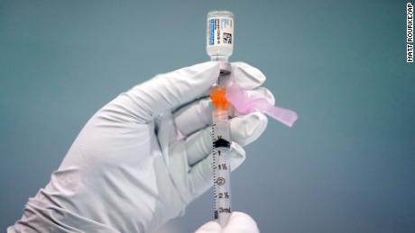 In this March 26 file photo, a member of the Philadelphia Fire Department prepares a dose of the Johnson &amp; Johnson Covid-19 vaccine at a vaccination site in Philadelphia.