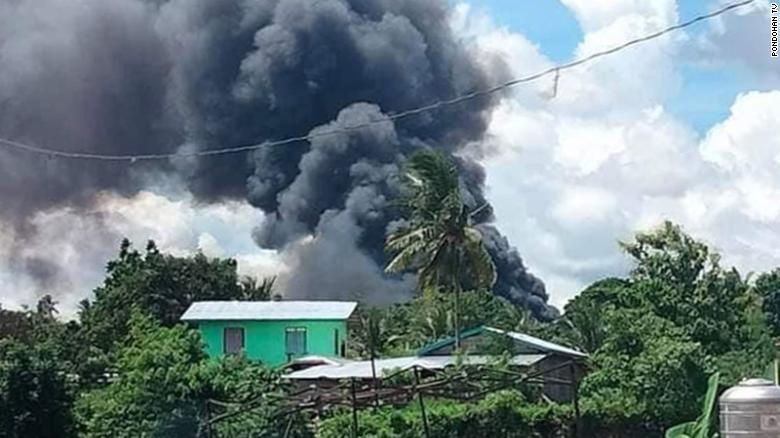 Smoke billows from the crash site in Patikul village, Jolo in the southern Philippines on July 4, 2021.