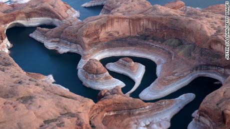 The tall bleached &quot;bathtub ring&quot; is visible on the rocky banks of Lake Powell at Reflection Canyon on June 24, 2021, in Lake Powell, Utah.