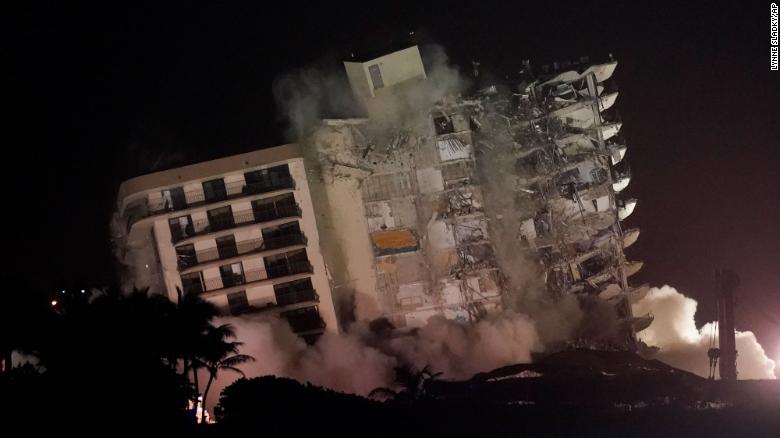 The damaged remaining structure at the Champlain Towers South condo building collapses in a controlled demolition, Sunday in Surfside, Florida.