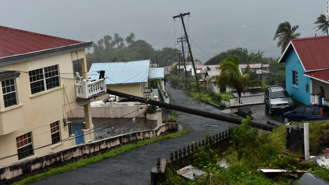 An electrical pole felled by Hurricane Elsa leans on the edge of a residential balcony in St. Vincent on Friday. The Gulf Coast of Florida can expect impacts from Elsa -- now a tropical storm -- beginning Monday night in the Keys.