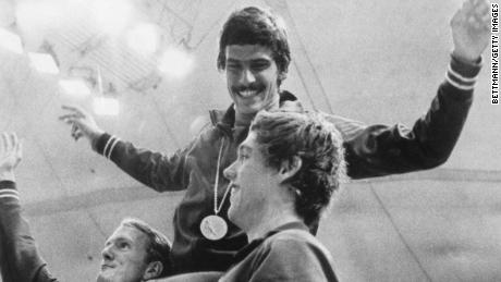 American swimmers Tom Bruce (left) and Mike Stamm (right) carry teammate Mark Spitz on their shoulders at the 1972 Olympics in Munich.