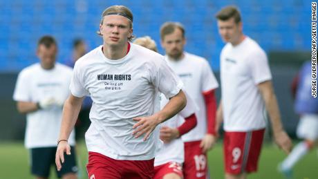 During 2021 there have even been concerns about the 2022 World Cup among players on the pitch. Norway's forward Erling Braut Haaland is pictured wearing a t-shirt with the slogan &quot;Human rights, on and off the pitch&quot; as he warms up before the FIFA World Cup Qatar 2022 qualification football match between Norway and Turkey at La Rosaleda stadium in Malaga on March 27, 2021. 