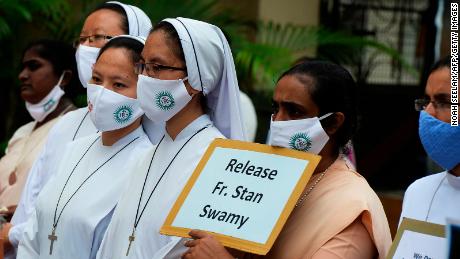 Catholic nuns hold placards during a protest against the arrest of Jesuit priest Father Stan Swamy on October 21, 2020.