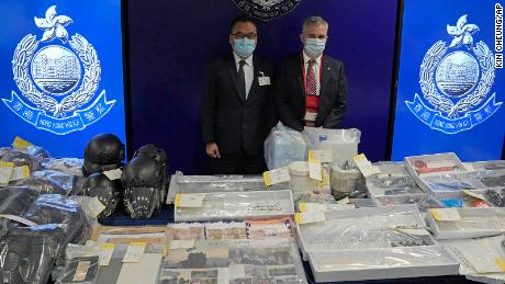 Senior Superintendent Steve Li , left, of Hong Kong Police National Security Department, and senior bomb disposal officer Alick McWhirter, right, of Explosive Ordnance Disposal Bureau, pose with the confiscated evidence during a news conference Tuesday.