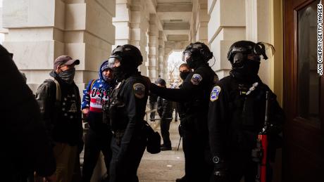 Capitol Police in riot gear face off against a group of pro-Trump protesters after removing them from the Capitol Building on January 6, 2021 in Washington, DC. 