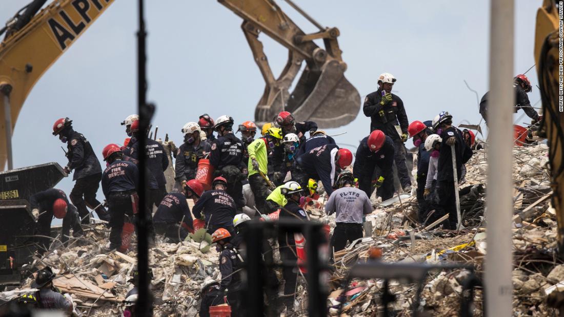 Crews work at the site of the collapsed building on July 6.