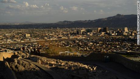 People look towards the downtown El Paso and the US-Mexico border separating El Paso and the Mexican city of Ciudad Juarez, Chihuahua state, Mexico, from Murchison Rogers Park along Scenic Drive at sunset on June 24, 2021 in El Paso, Texas.