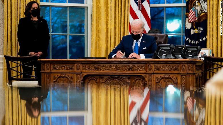 President Joe Biden signs several executive orders on immigration on February 2 in the Oval Office.