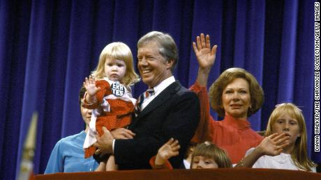 Then-President Jimmy Carter holding his granddaughter Sarah, being flanked by his wife Rosalynn and daughter Amy, at the Democratic National Convention.  