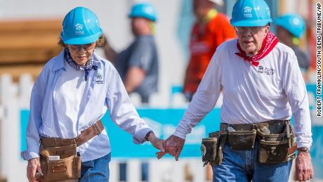 Jimmy and Rosalynn Carter hold hands as they work with other volunteers on site during the first day of the weeklong Jimmy &amp; Rosalynn Carter Work Project, their 35th work project with Habitat for Humanity, in Mishawaka, Indiana in 2018.