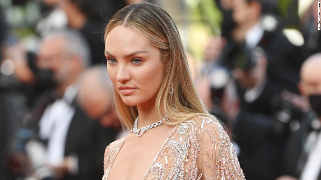 Candice Swanepoel stepped out in an embellished nude-toned jumpsuit with wide fringed sleeves.