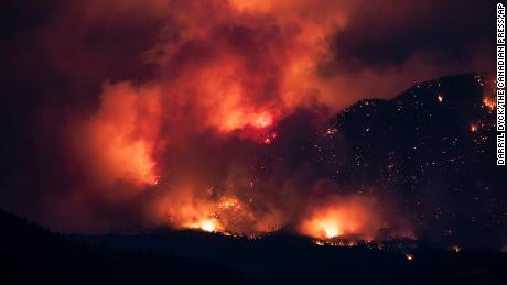 A wildfire burns on the side of a mountain in Lytton, British Columbia, on July 1.