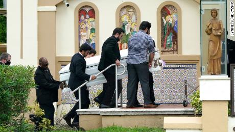 Pallbearers carry the casket of two sisters killed in the Sunrise, Florida, condo collapse. 