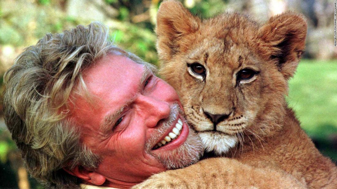 Branson cuddles with a young lion cub at South Africa&#39;s Sun City resort in 1996.