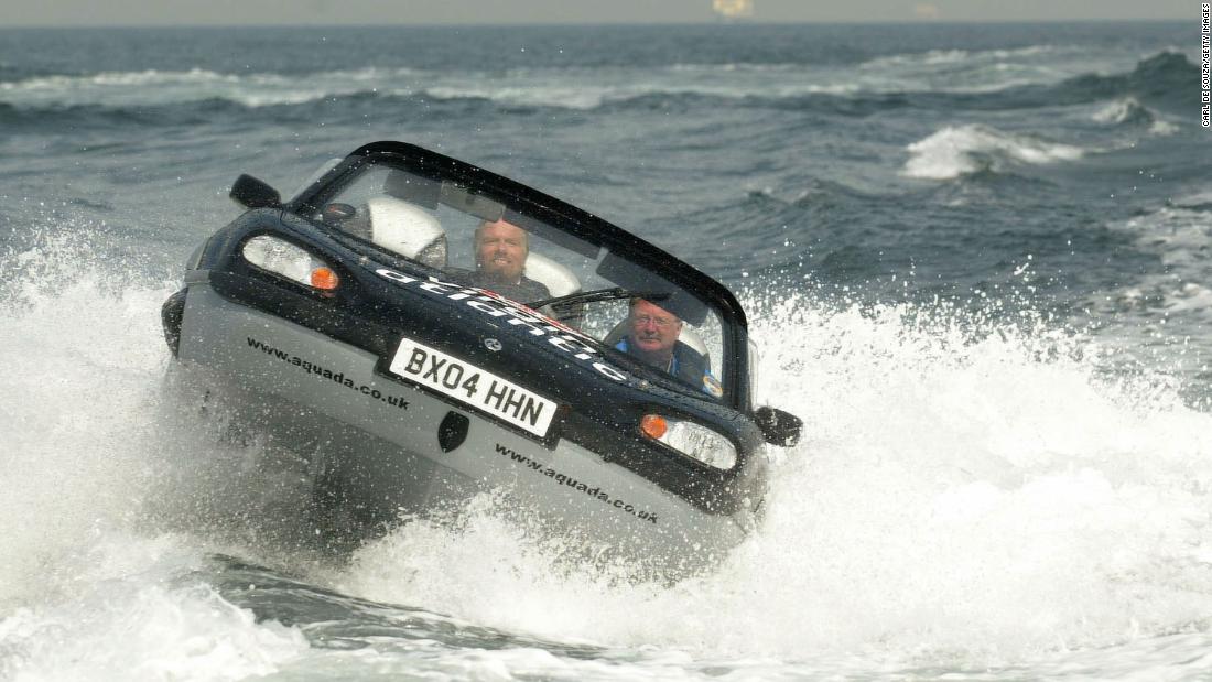 Branson, left, pilots an amphibious vehicle during a record-breaking crossing of the English Channel in 2004. He crossed the channel in one hour, 40 minutes and six seconds.