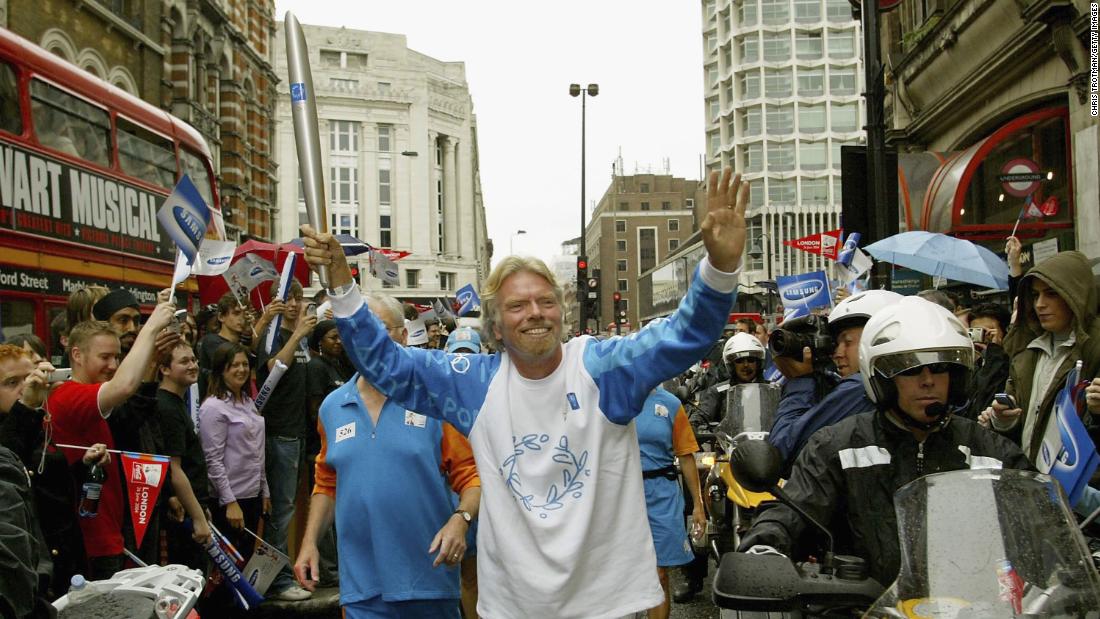 Branson runs with the Olympic torch in London in 2004, ahead of the Olympic Games that year in Athens, Greece.