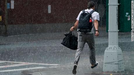 A man runs through the rain in the Chelsea area of New York on Thursday.
