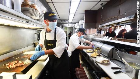 Kitchen staff prepare breakfast at Langer's Delicatessen-Restaurant in Los Angeles on June 15, the first day of its California economy fully reopening after fifteen months of Covid restrictions.