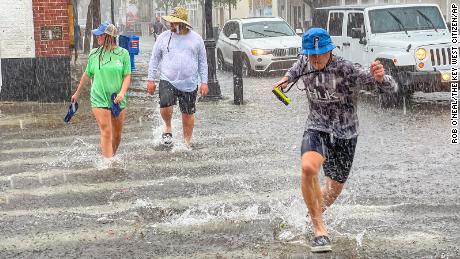 Pedestrians dash across a street in Key West, Florida, on Tuesday.