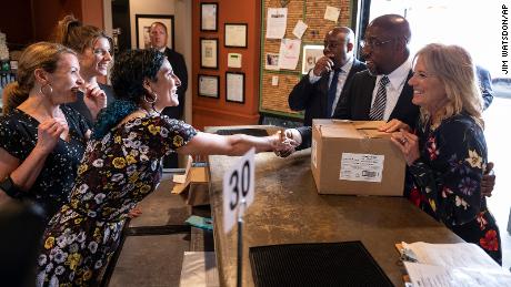 First lady Jill Biden gets a pie to-go at Green Truck Neighborhood Pub in Savannah, Ga., Thursday, July 8, 2021. Sen. Raphael Warnock, D-Ga., second from right, and Savannah Mayor Van Johnson look on. (Jim Watson/Pool via AP)