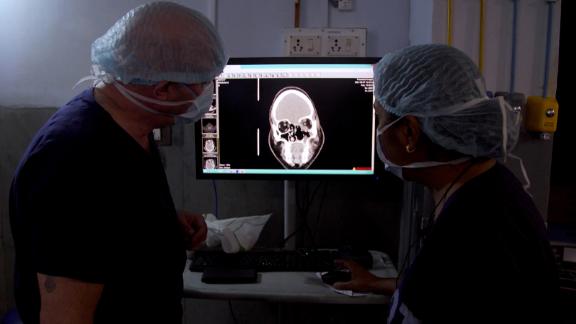Surgeons examine an X-ray for signs of infection in Srinivas' brain.