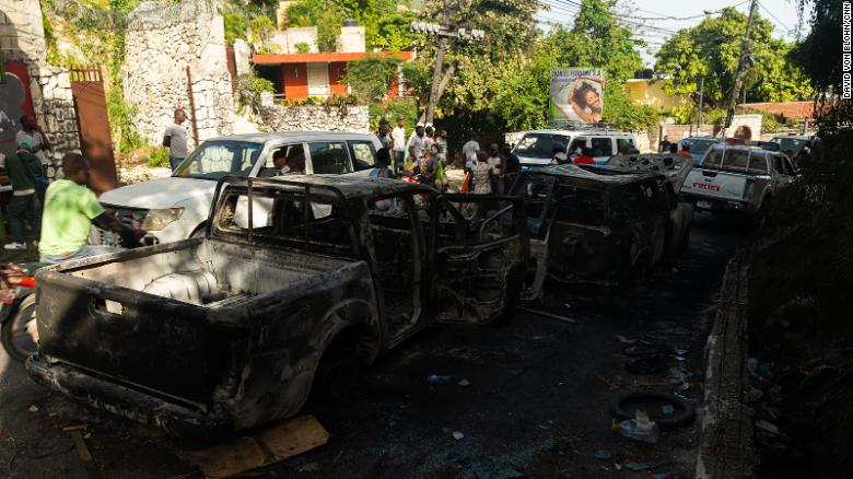 Burnt out cars line the street near the late President&#39;s residence in Haiti. 
