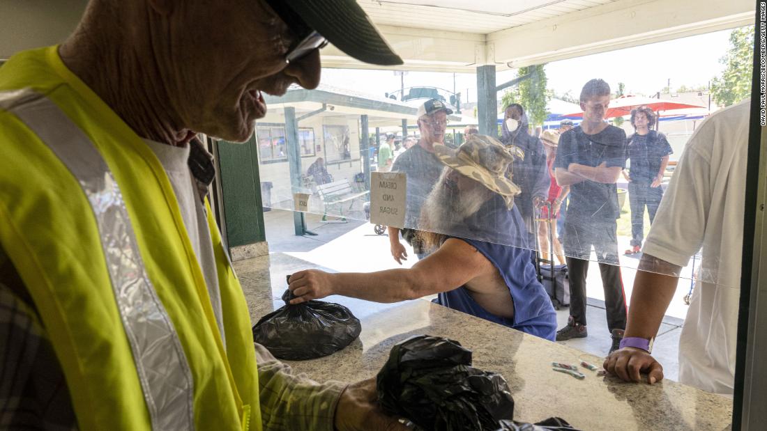 Volunteers hand out water and ice at a homeless-services facility in Sacramento, California, on July 8.