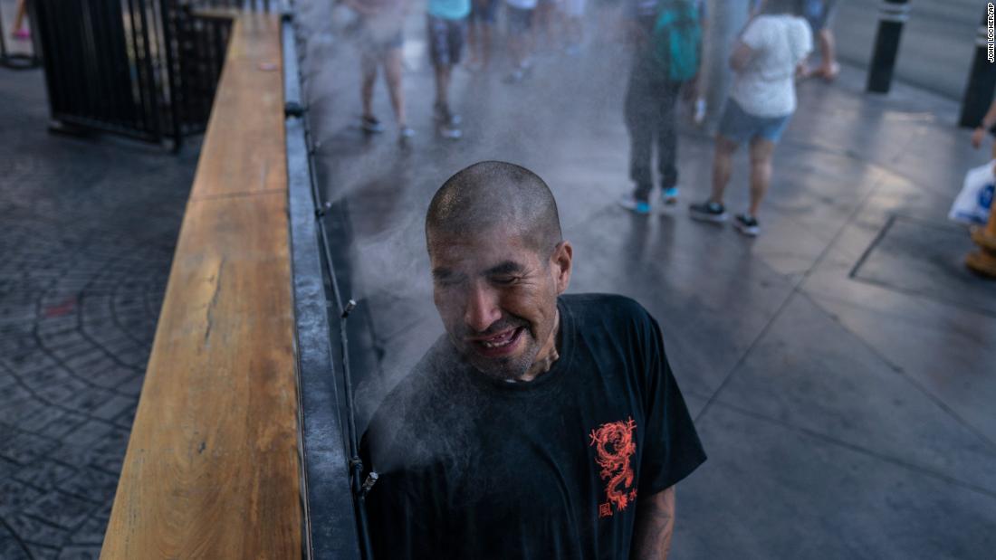 Golden Davis cools off in a mister along the Las Vegas Strip on July 9. The city tied its all-time temperature record of 117 degrees Fahrenheit over the weekend.