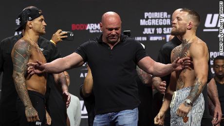 Dustin Poirier and Conor McGregor pose during a ceremonial weigh in for UFC 264 at T-Mobile Arena on July 9, 2021 in Las Vegas.