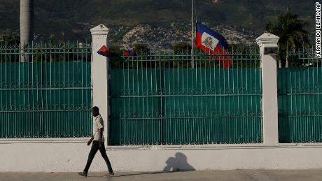 The Haitian flag flies at half-mast at the Presidential Palace in Port-au-Prince, Haiti, on July 10, three days after President Jovenel Moise was assassinated in his home. 