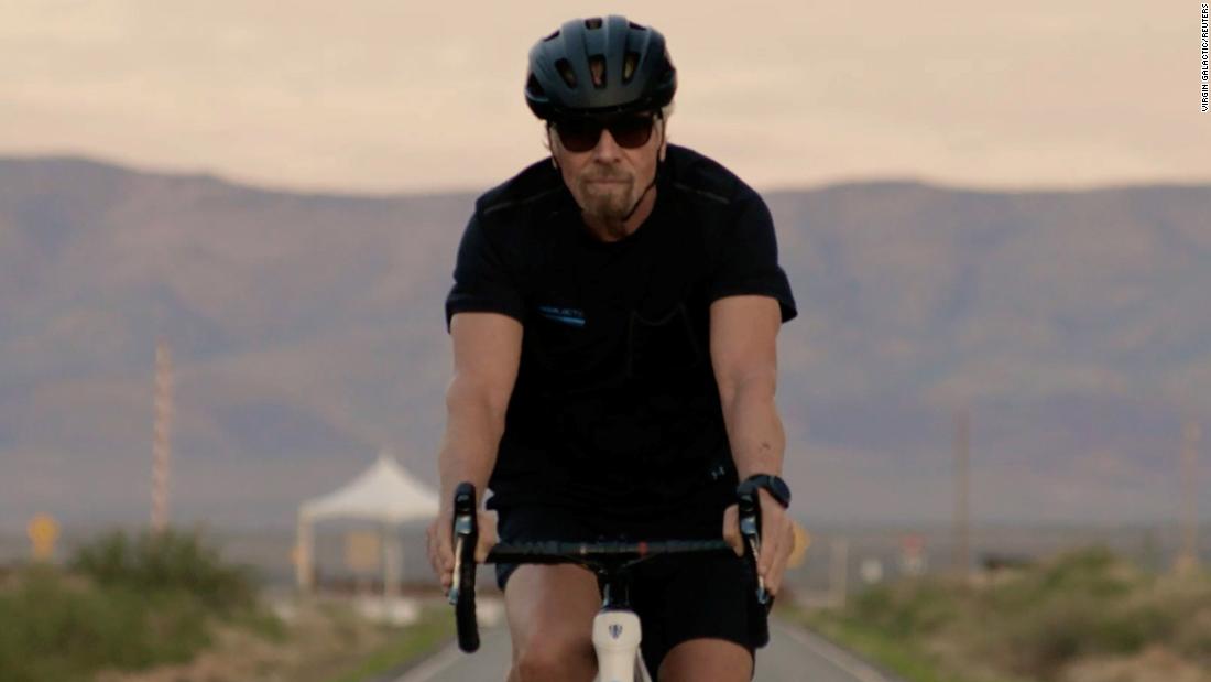 Branson arrives at Spaceport America by bicycle just after sunrise.