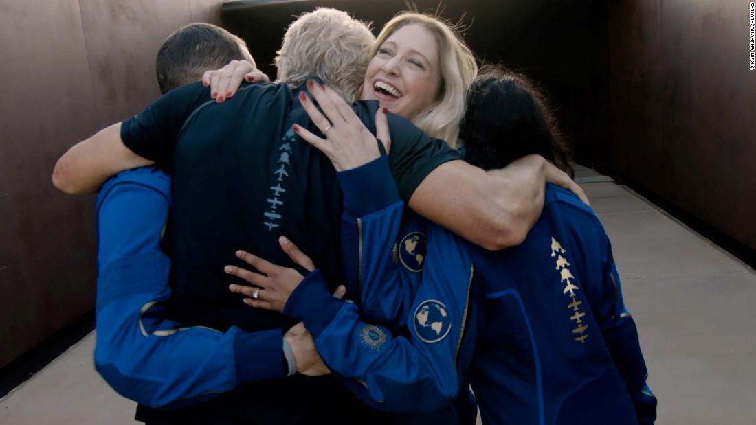 Virgin Galactic&#39;s chief astronaut instructor Beth Moses embraces Branson and other crew members ahead of the spaceflight.