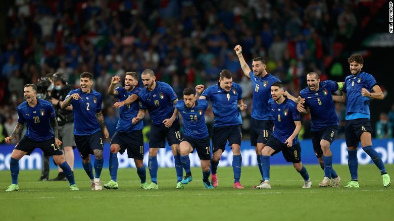 Italy players celebrate winning the penalty shootout against England. 