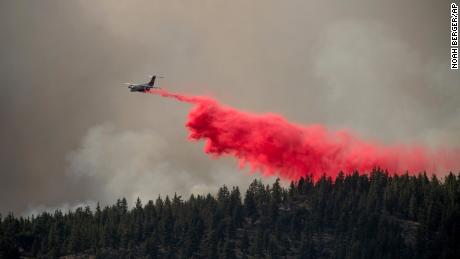 An air tanker drops retardant Friday to keep the Sugar Fire, part of the Beckwourth Complex Fire, from reaching the Beckwourth community in Plumas County, California.