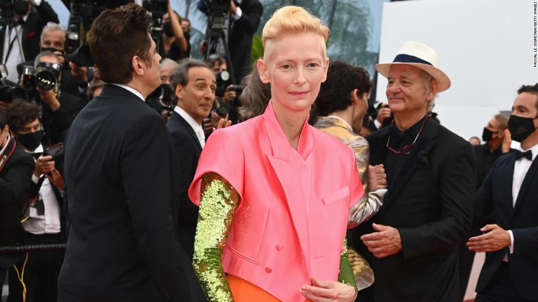 Tilda Swinton stepped out in an unmissable Haider Ackermann outfit with a cropped pink suit jacket and metallic sleeves.