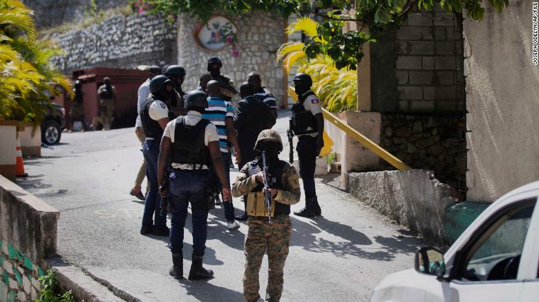 Security forces conduct an investigation as a soldier stands guard at the entrance to the residence of Haitian President Jovenel Moise, in Port-au-Prince, Haiti, Wednesday, July 7, 2021. 