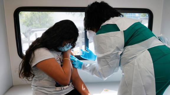 Jenna Ramkhelawan, 12, receives the first dose of the Pfizer Covid-19 vaccine from LPN nurse Dolores Fye, Tuesday, May 18, 2021, in Miami. (AP Photo/Marta Lavandier)